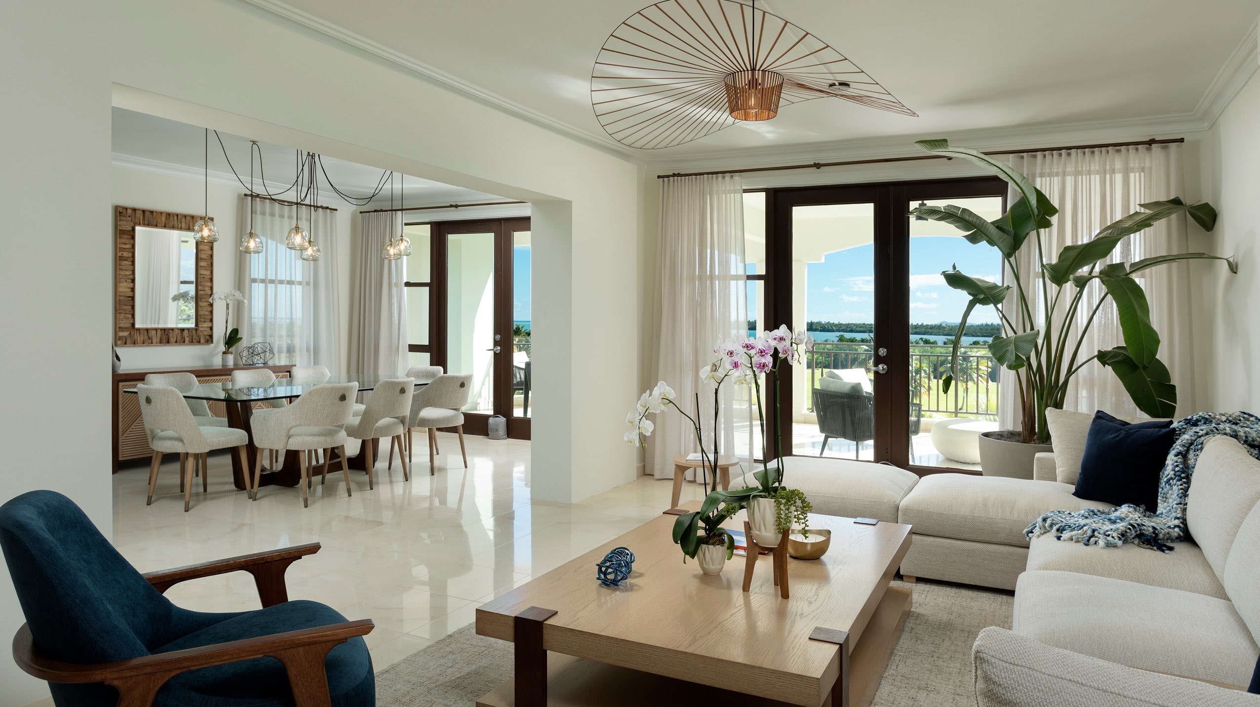 Expansive living and dining area at the Celeste Country Club Residences, featuring modern decor, natural light, and views that bring the outside in.