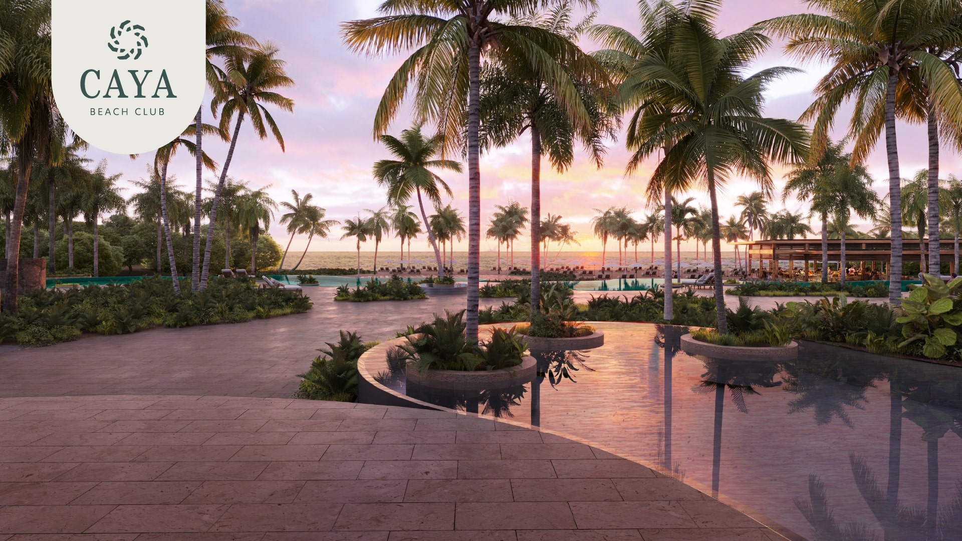 Twilight view of Caya Beach Club at Grand Reserve, with a serene pool reflecting the vibrant sunset and tropical palm trees, embodying luxurious relaxation.